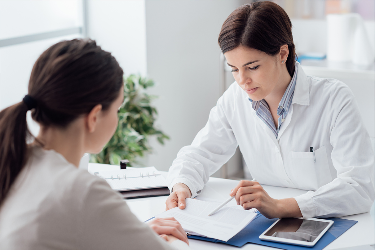 Clinician and patient reviewing medical records together during treatment planning