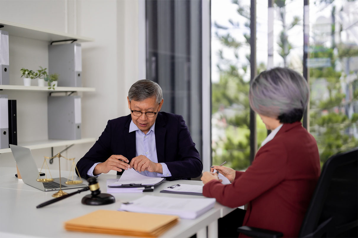 Legal professionals reviewing documents and discussing negotiated positions